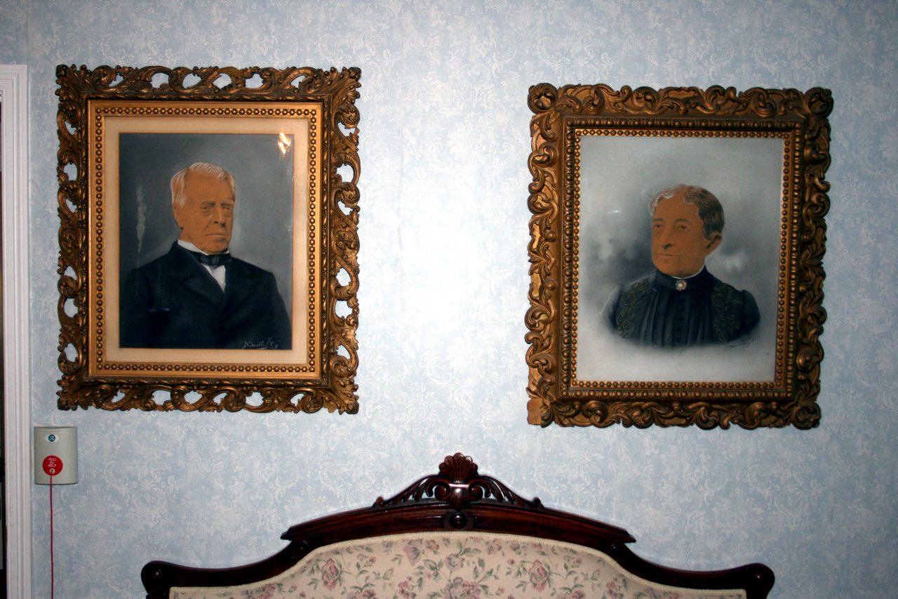 Two framed 19th-century ancestor portraits on a wall